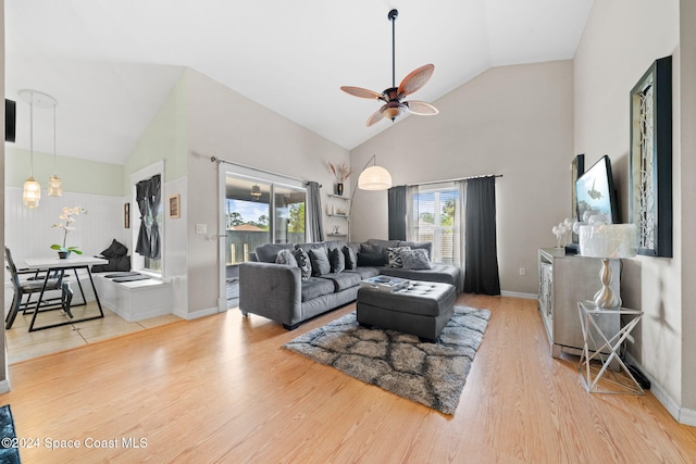 living room with ceiling fan, wood-type flooring, and high vaulted ceiling