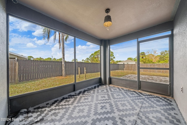 unfurnished sunroom with a wealth of natural light