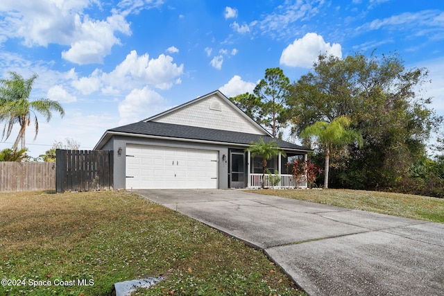 view of front of home with a garage and a front lawn