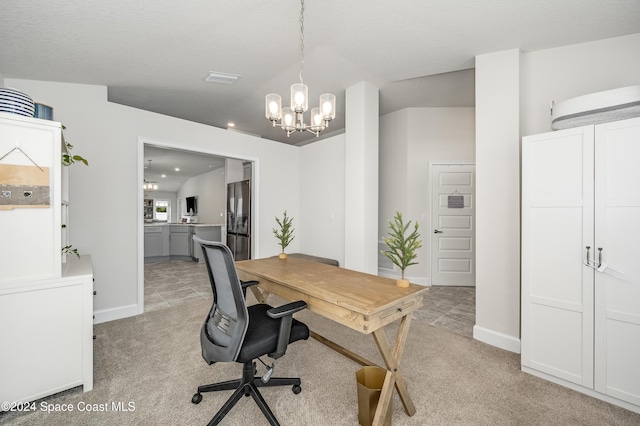 carpeted office space with a textured ceiling and a notable chandelier