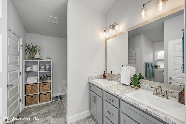 bathroom featuring vanity and a textured ceiling