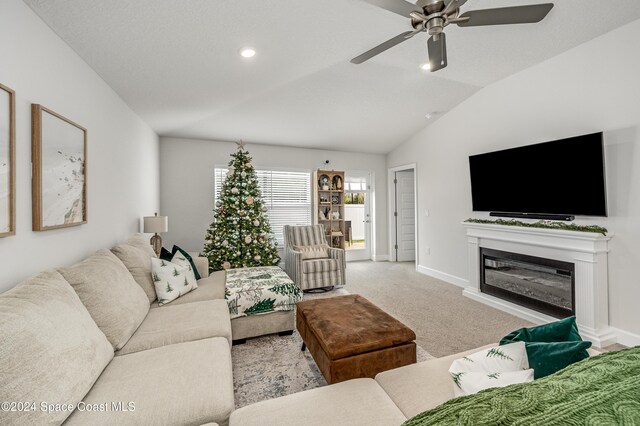 living room featuring light colored carpet, ceiling fan, and lofted ceiling