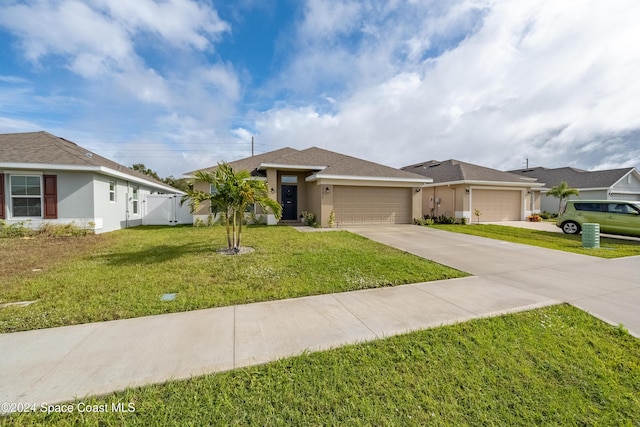 view of front of house featuring a front yard and a garage