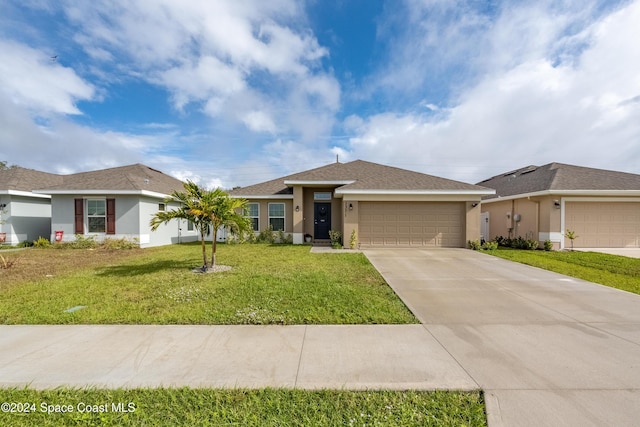 view of front facade with a front yard and a garage