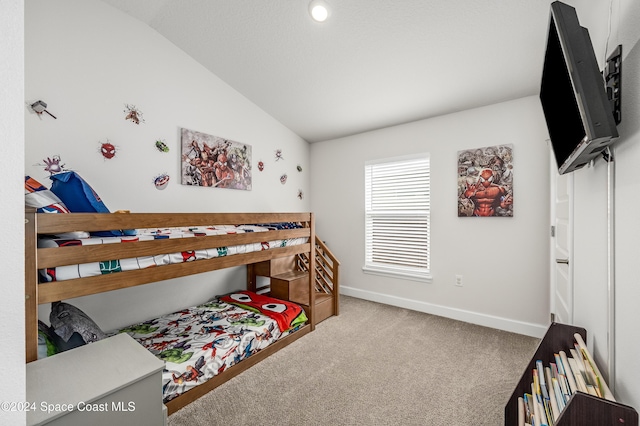 carpeted bedroom with vaulted ceiling