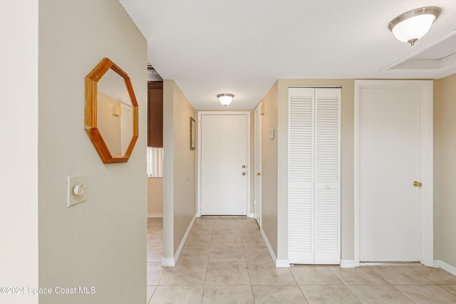 hallway featuring light tile patterned floors