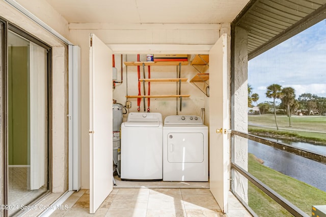 laundry room with washer and clothes dryer and light tile patterned floors