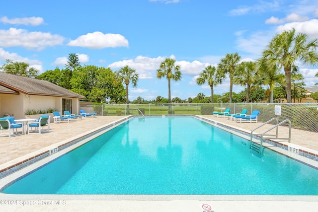 view of swimming pool with a patio area