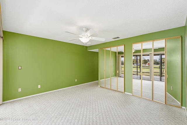 empty room featuring ceiling fan and carpet floors