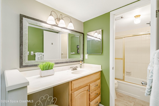 full bathroom featuring tile patterned flooring, vanity, toilet, and shower / bath combination with glass door