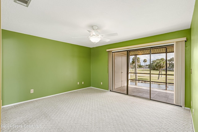 unfurnished room featuring ceiling fan and carpet floors