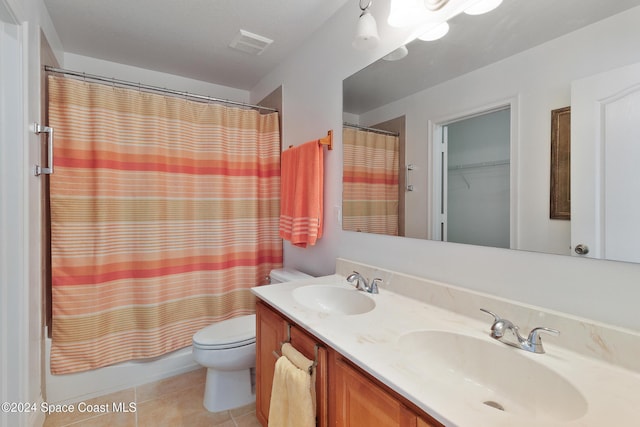 full bathroom with tile patterned flooring, vanity, shower / bath combo, and toilet