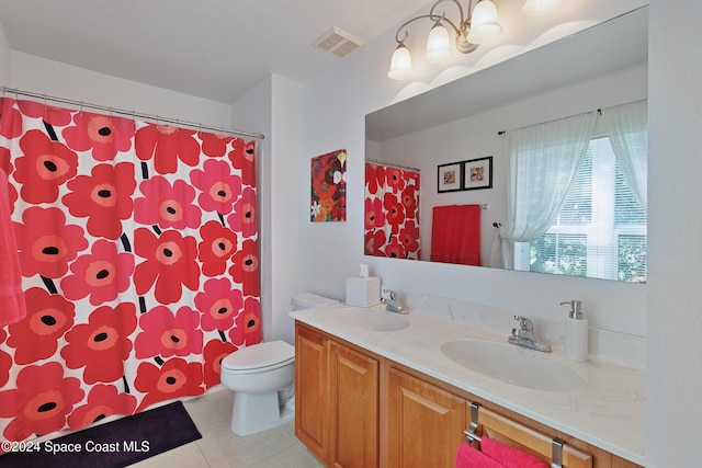 bathroom with tile patterned flooring, vanity, and toilet