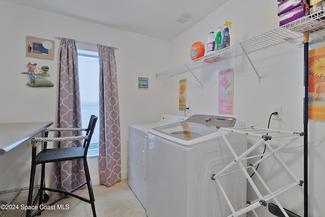 washroom with light carpet and washer and clothes dryer