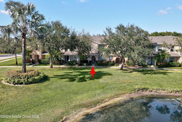 exterior space with a water view and a front yard