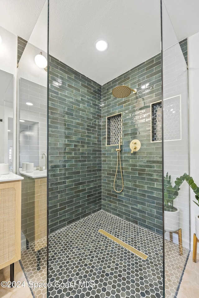 bathroom with walk in shower and tile patterned floors