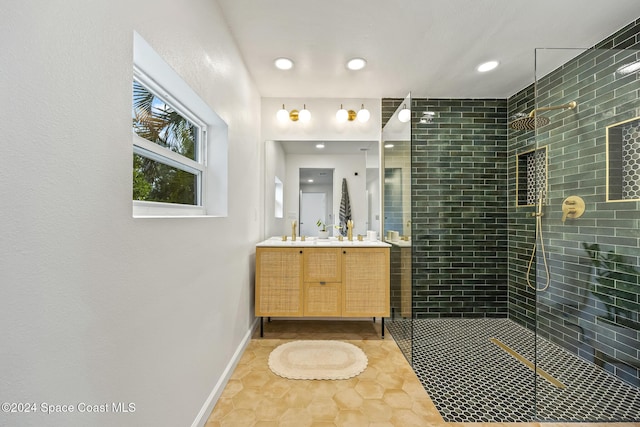 bathroom with vanity, tile patterned floors, and a tile shower