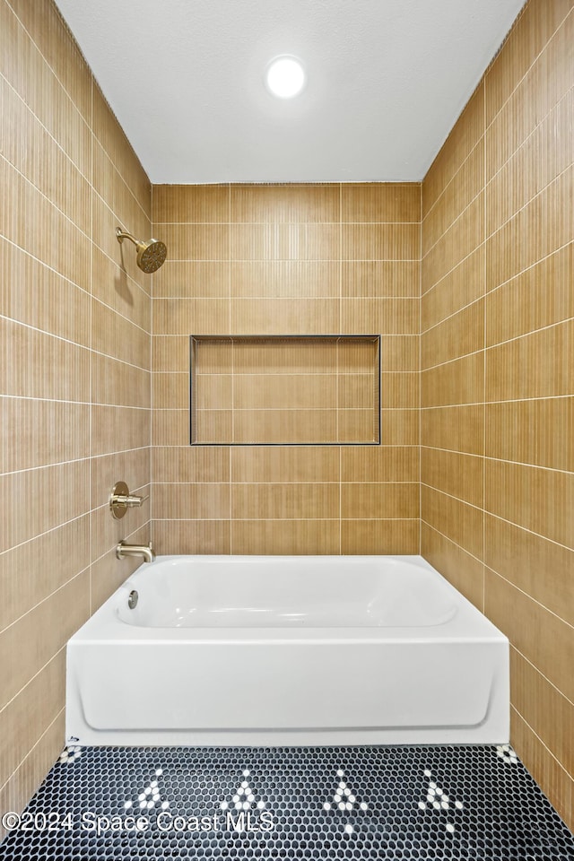 bathroom featuring tile walls, tile patterned flooring, and shower / bathtub combination