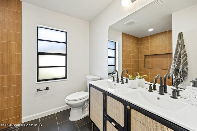 bathroom with vanity, tile patterned floors, and toilet