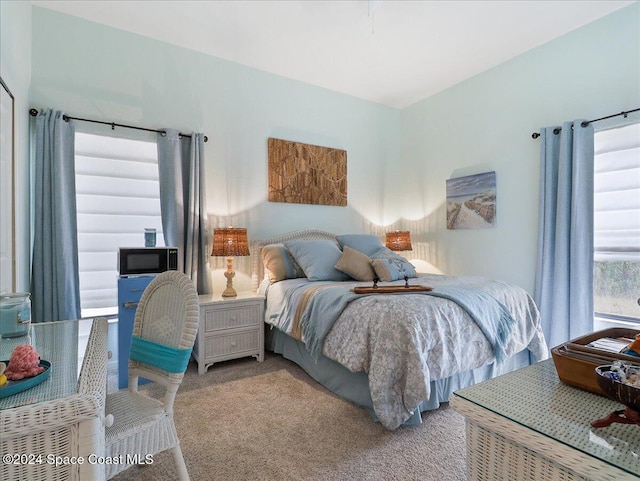 bedroom featuring light carpet