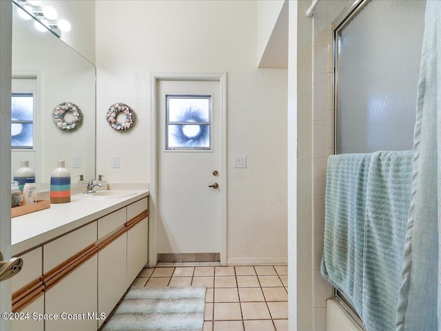 bathroom featuring tile patterned floors, vanity, and an enclosed shower