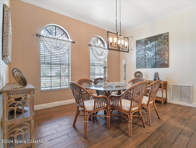 dining room featuring dark hardwood / wood-style floors and ornamental molding