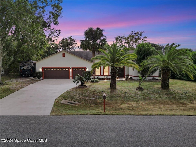 view of front facade featuring a yard and a garage