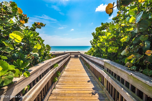 surrounding community featuring a water view and a view of the beach