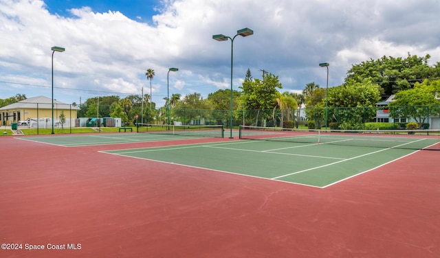 view of tennis court with basketball hoop