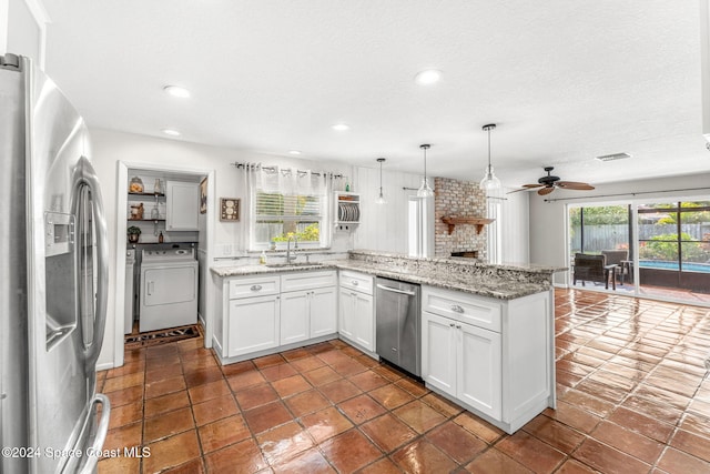 kitchen with pendant lighting, kitchen peninsula, ceiling fan, appliances with stainless steel finishes, and white cabinetry