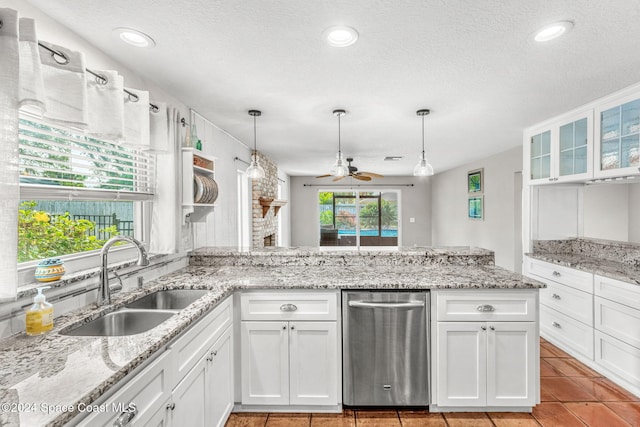 kitchen with a textured ceiling, ceiling fan, white cabinetry, and sink