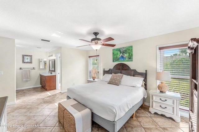 tiled bedroom featuring multiple windows, ceiling fan, and a textured ceiling