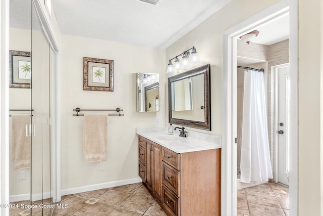 bathroom with a textured ceiling and vanity