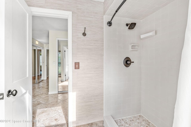 bathroom with tile patterned floors and walk in shower