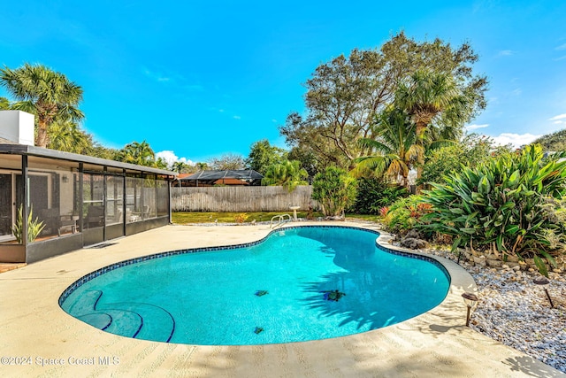 view of pool featuring a patio area and a sunroom