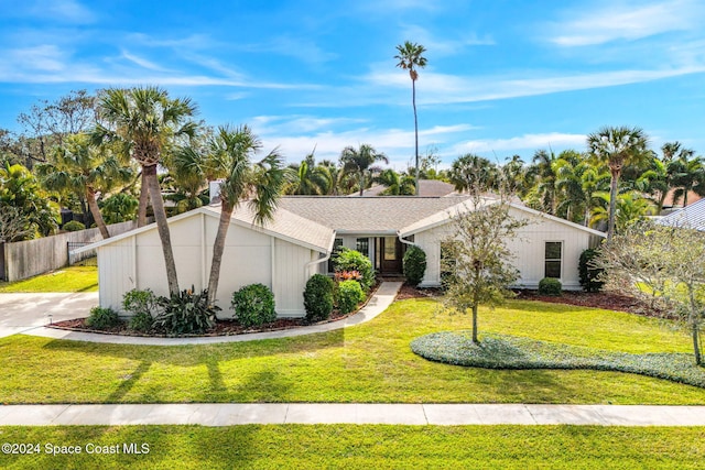 ranch-style home with a front lawn