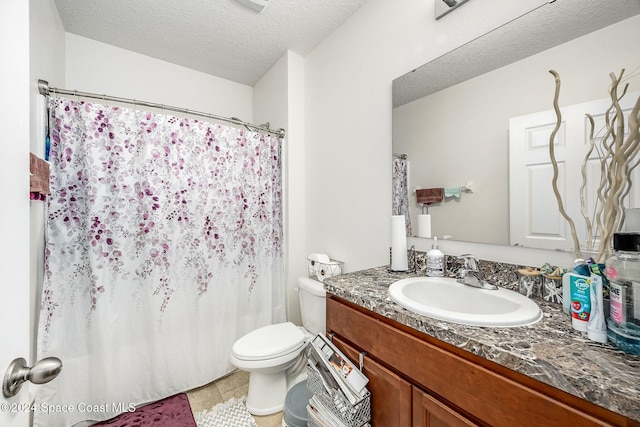 bathroom featuring tile patterned flooring, vanity, a textured ceiling, and toilet