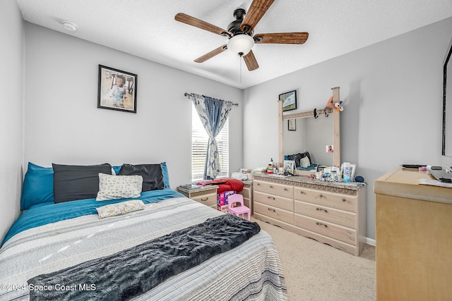 bedroom with carpet flooring, ceiling fan, and a textured ceiling