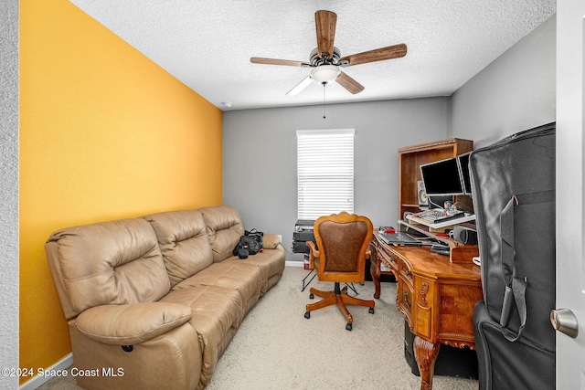 office area featuring a textured ceiling, carpet floors, and ceiling fan