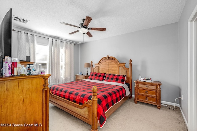 bedroom featuring ceiling fan and a textured ceiling