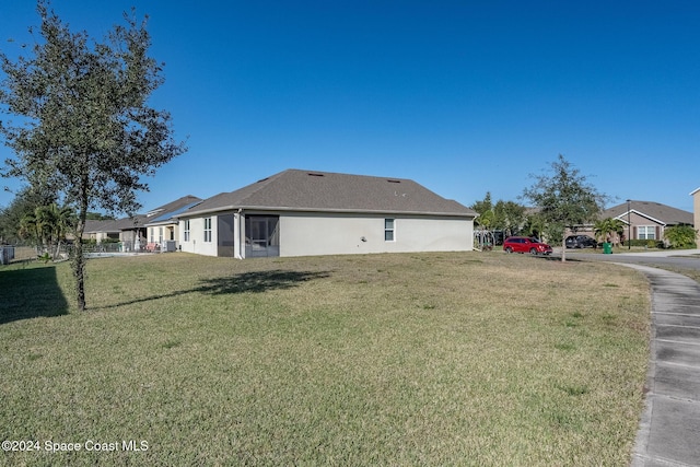 view of side of property with a lawn