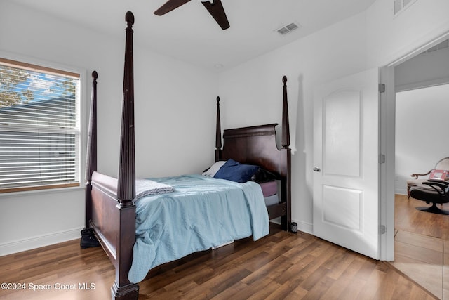 bedroom with ceiling fan and dark wood-type flooring