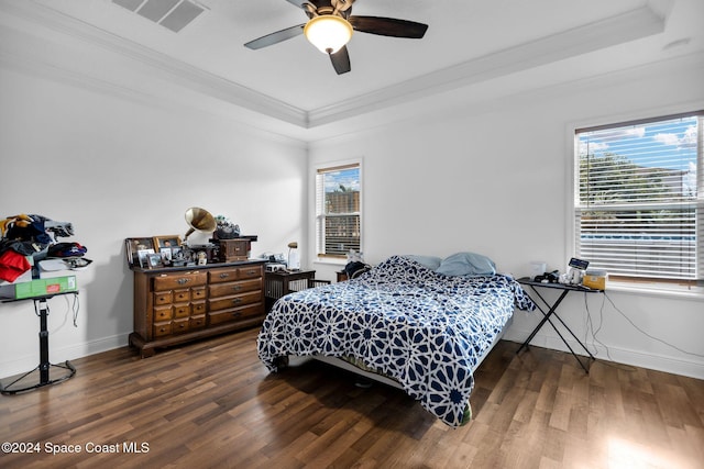 bedroom with dark hardwood / wood-style floors, ceiling fan, crown molding, and multiple windows