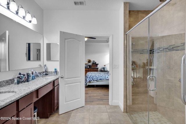 bathroom with an enclosed shower, hardwood / wood-style floors, vanity, and ceiling fan