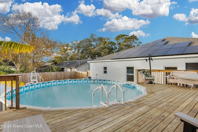 view of pool with a wooden deck