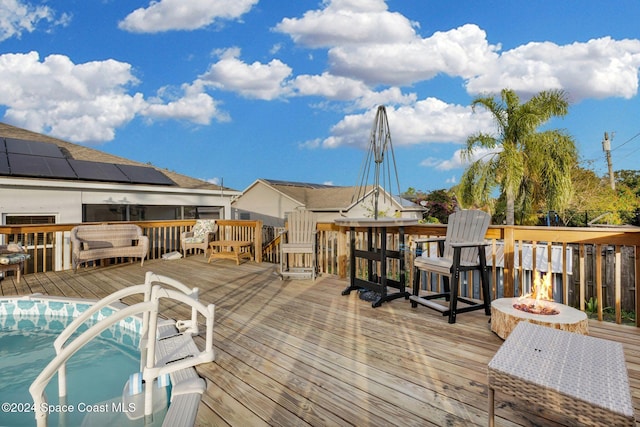 wooden deck with a fire pit