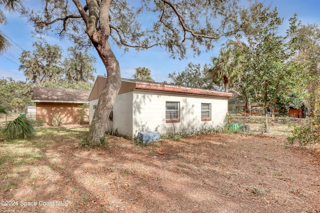 view of side of home with a storage shed