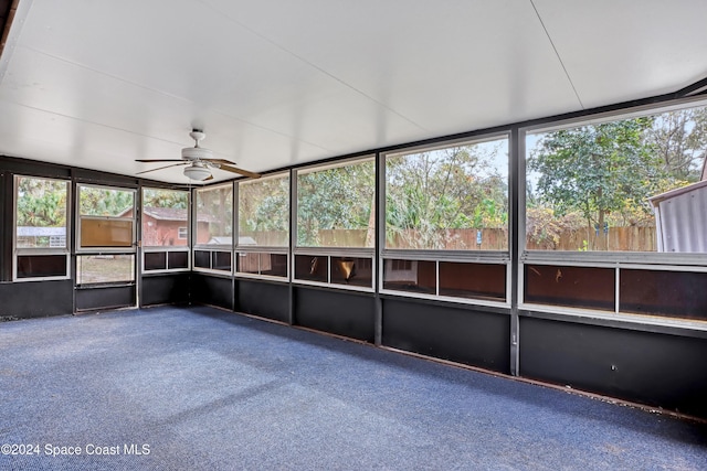 unfurnished sunroom featuring ceiling fan