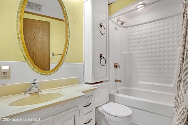 full bathroom featuring shower / bath combination with curtain, toilet, decorative backsplash, vanity, and tile walls