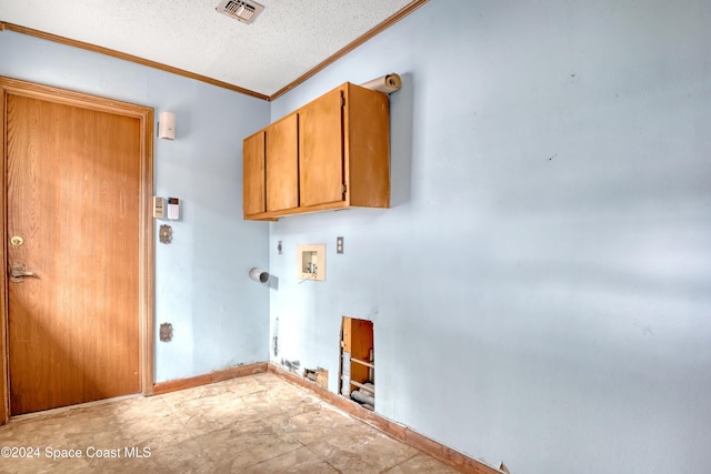 clothes washing area with cabinets, hookup for a washing machine, ornamental molding, a textured ceiling, and electric dryer hookup